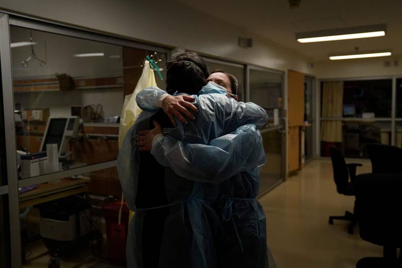A chaplain and nurse comfort each other at Providence Holy Cross Medical Center in Los Angeles, US. AP Photo