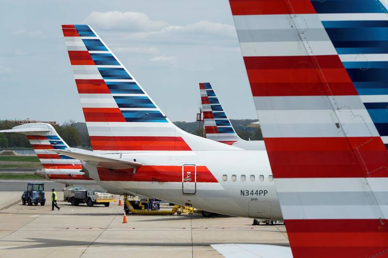 FILE PHOTO: A member of a ground crew walks past American Airlines planes parked at the gate during the coronavirus disease (COVID-19) outbreak at Ronald Reagan National Airport in Washington, U.S., April 5, 2020.      REUTERS/Joshua Roberts -/File Photo