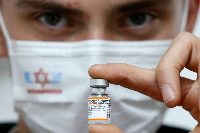 A nurse holds a vial of the Pfizer-BioNtech vaccine, in the Israeli town of Ramat Gan, near Tel Aviv. Israelis over the age of 60 and medical teams are being offered a fourth Covid shot.