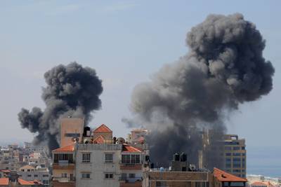 Smoke billows from residential buildings following Israeli airstrikes in Gaza City. AFP