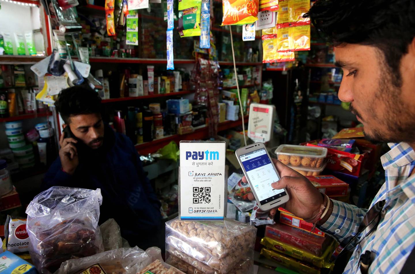 An Indian shopkeeper receives payment by paytm mobile phone technology in Bhopal. EPA