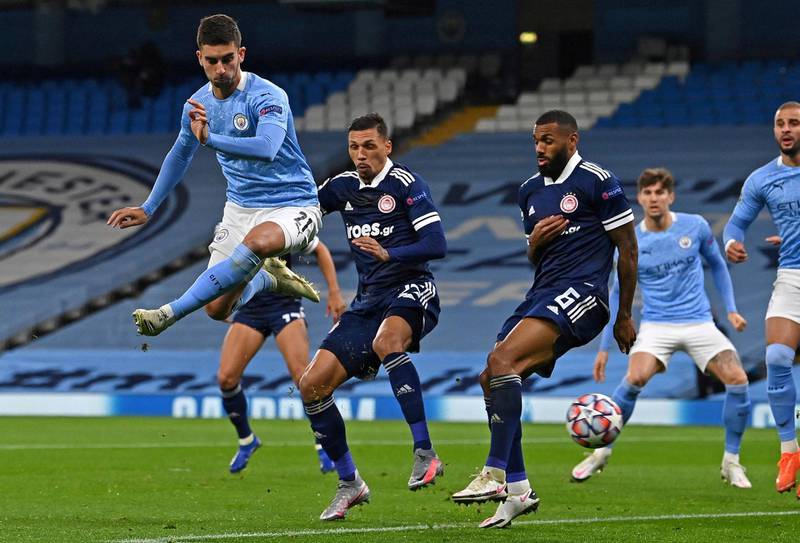 Manchester City's Spanish midfielder Ferran Torres (L) shoots wide of the post during the UEFA Champions League football Group C match between Manchester City and Olympiakos at the Etihad Stadium in Manchester, north west England on November 3, 2020. (Photo by Paul ELLIS / AFP)