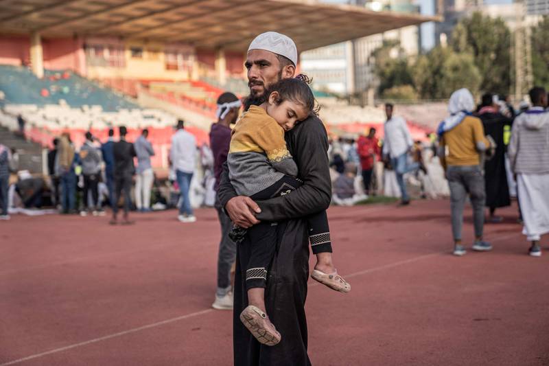 A man holds a child while attending the Eid Al Fitr morning prayers at a football stadium in Addis Ababa, Ethiopia. AFP