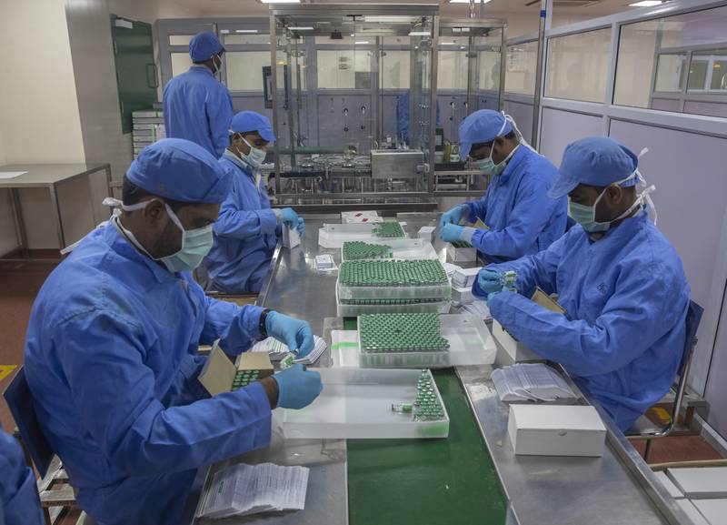 Employees pack boxes containing vials of Covishield, a version of the AstraZeneca vaccine, at the Serum Institute of India in Pune. AP