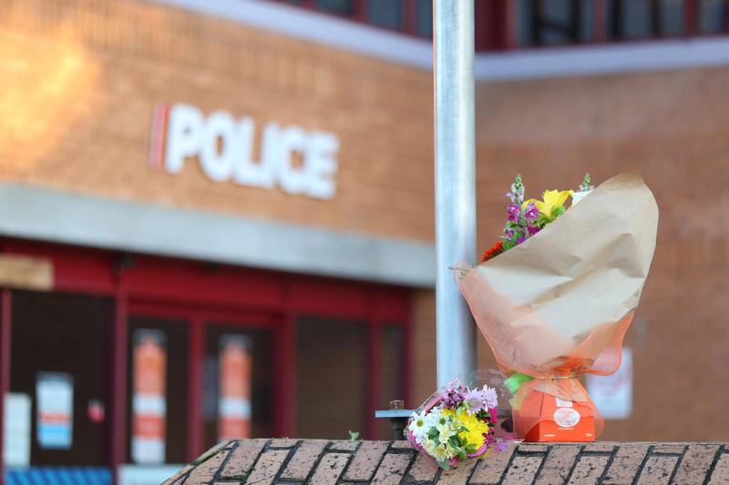 Flowers are left outside the Henderson Police station in Auckland, New Zealand. A police officer has died and another is injured following a shooting during a traffic stop in the Auckland suburb of Massey. Getty Images