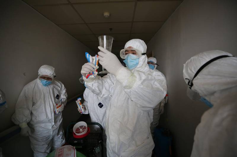 Workers prepare to disinfect rooms at the Red Cross hospital in Wuhan, in China's central Hubei province on March 18, 2020. The hospital, which has been used to treat COVID-19 coronavirus patients, will be temporarily closed from March 18 for a week of extensive disinfection, before being returned to service as a general hospital. - China OUT
 / AFP / STR
