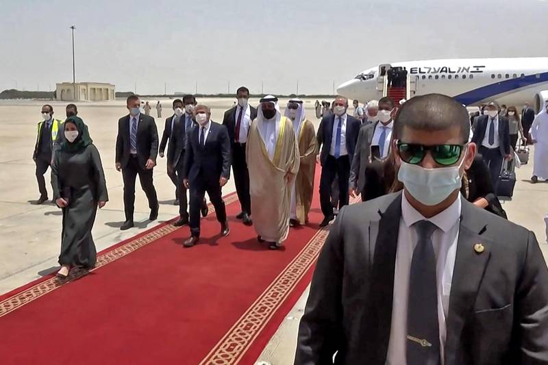 Emirati officials welcome Israeli Foreign Minister Yair Lapid upon his arrival at Abu Dhabi airport on Tuesday. Mr Lapid was making the first official trip by an Israeli minister to the UAE after the two countries normalised ties last year. AFP