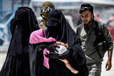 An internal security patrol escorts women, reportedly wives of ISIS fighters, in the Al Hol camp northeastern Syria. AFP 
