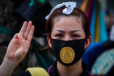 A Thai pro-democracy activist with a sticker of the memorial plaque of the 1932 Siamese Revolution on her mask, attends an anti-government protest outside the parliament in Bangkok, Thailand, 24 September. Diego Azubel/ EPA