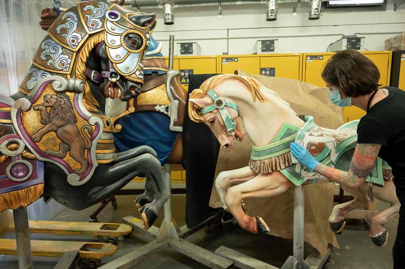 A worker repairs carousel horses in Disneyland Paris. The theme park will reopen on June 17. AFP