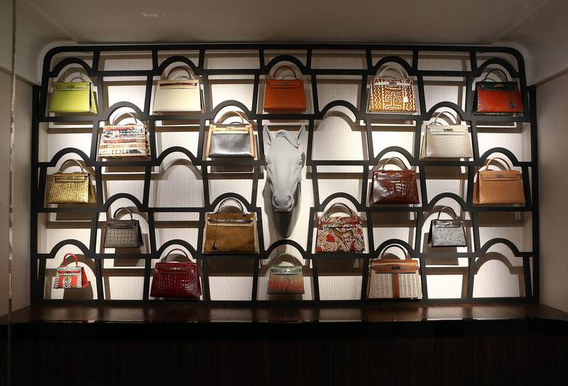 A wall is covered in iconic Kelly bags, an homage the brand’s female customers. All, however, is not as it seems. The horse’s head in the centre, when no one is looking, playfully pokes its tongue out. Pawan Singh / The National