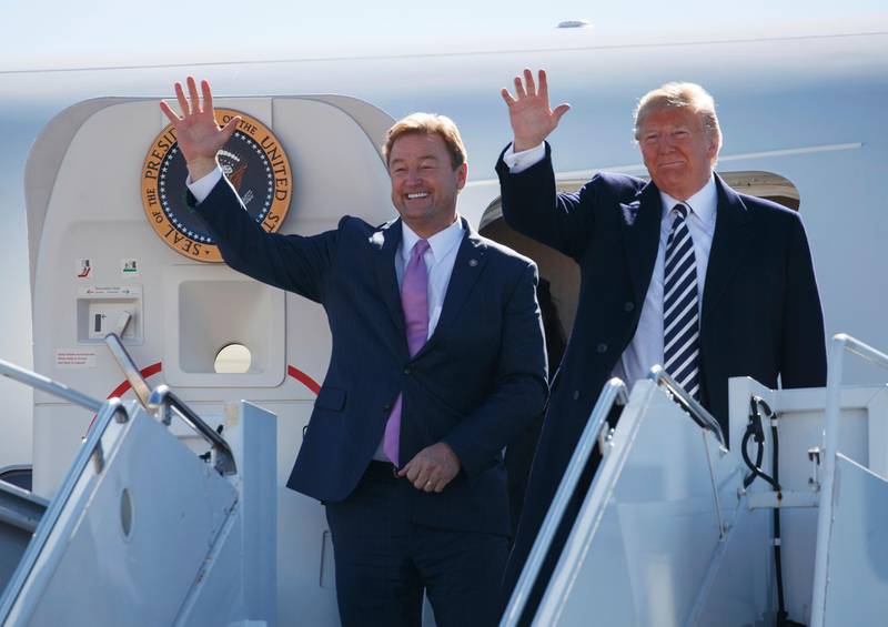 President Donald Trump arrives with Sen. Dean Heller, R-Nev., on Air Force One at Elko Regional Airport, Saturday, Oct. 20, 2018, in Elko, Nv., for a campaign rally. (AP Photo/Carolyn Kaster)