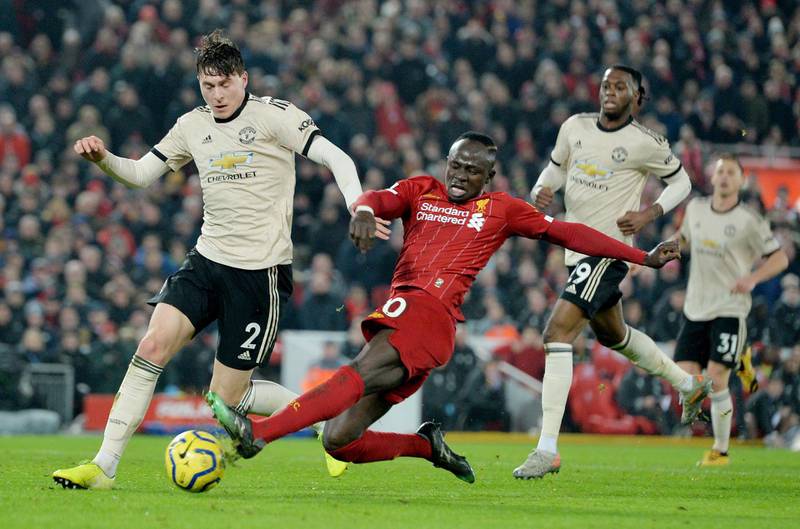 Liverpool's Sadio Mane (C) lunges in for a tackle on Manchester United's Victor Lindelof. EPA