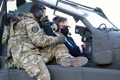 UK Minister for Defence Procurement Jeremy Quinn MP gets a tour of the cockpit of the AH-64E Apache, which is made by US aviation company Boeing.