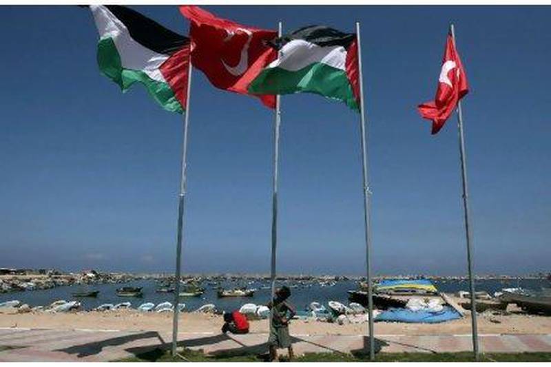 A Palestinian boy looks at the Turkish and Palestinian flags fluttering at the site of a monument (unseen) built to commemorate the first anniversary of the death of nine Turks, who were shot dead last May when Israeli naval commandos seized a Turkish ship that was part of a flotilla trying to break the Gaza blockade.  Mahmud Hams / AFP Photo