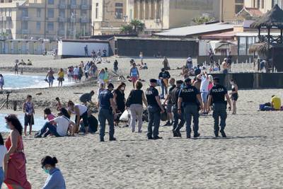 Italian police carry out anti-gathering checks along Ostia beach. AP