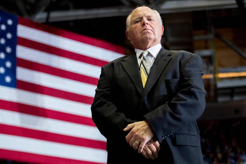 (FILES) In this file photo taken on November 05, 2018, US radio talk show host and conservative political commentator Rush Limbaugh looks on before introducing US President Donald Trump to deliver remarks at a Make America Great Again rally in Cape Girardeau, Missouri. Limbaugh, the US conservative radio host who spent more than four decades on the air, has died at aged 70 after a battle with cancer, his family said February 17, 2021. / AFP / Jim WATSON
