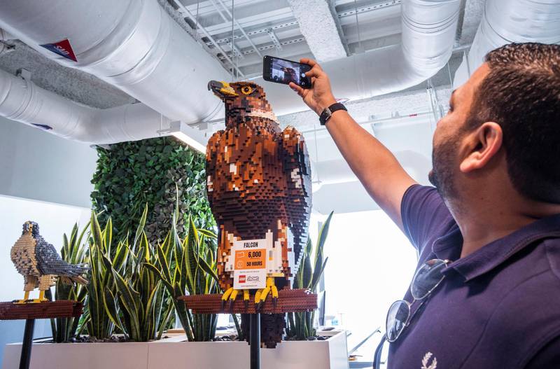 DUBAI, UNITED ARAB EMIRATES - A visitor taking shot of an eagle made of Lego at the opening of the new Lego office in Dubai Design District.  Leslie Pableo for The National
