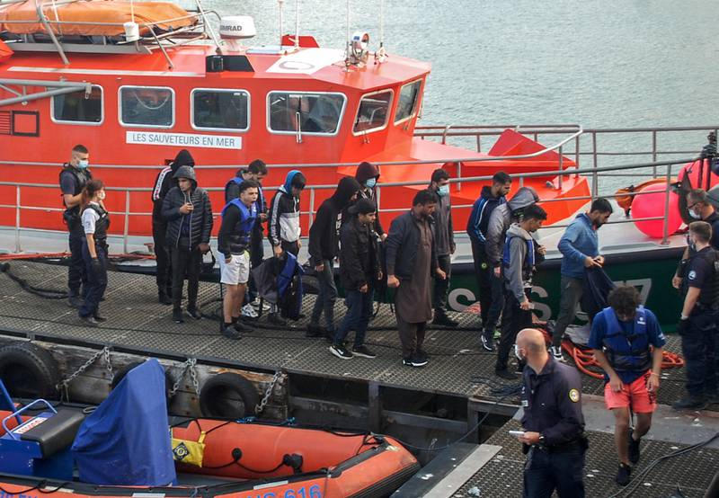 Iraqi, Iranian and Afghan migrants are escorted off a vessel on France’s northern coast after being rescued in the English Channel. Photo: AFP