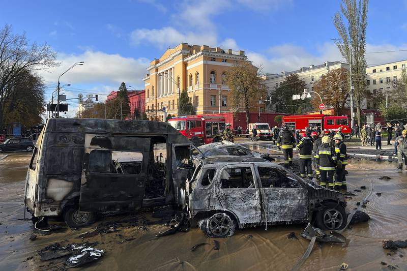Rescue workers survey the scene of a Russian attack on Kyiv. AP