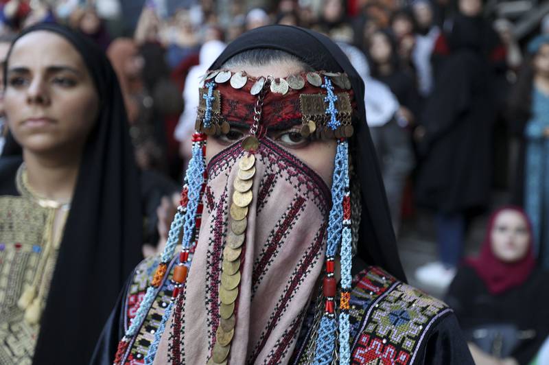 Women in the West Bank city of Ramallah celebrate Traditional Dress Day, an annual heritage event representing Palestinian costume, crafts such as embroidery, and song. AFP