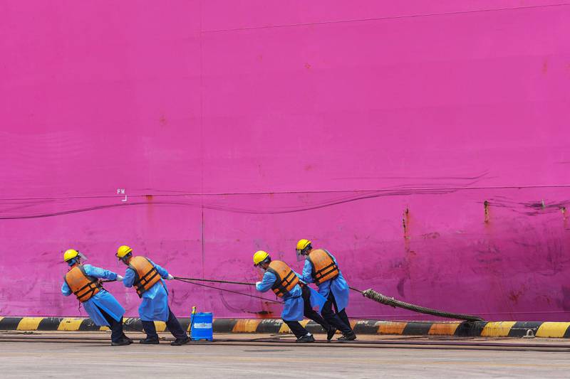 Port workers in Qingdao, in China's eastern Shandong province. AFP