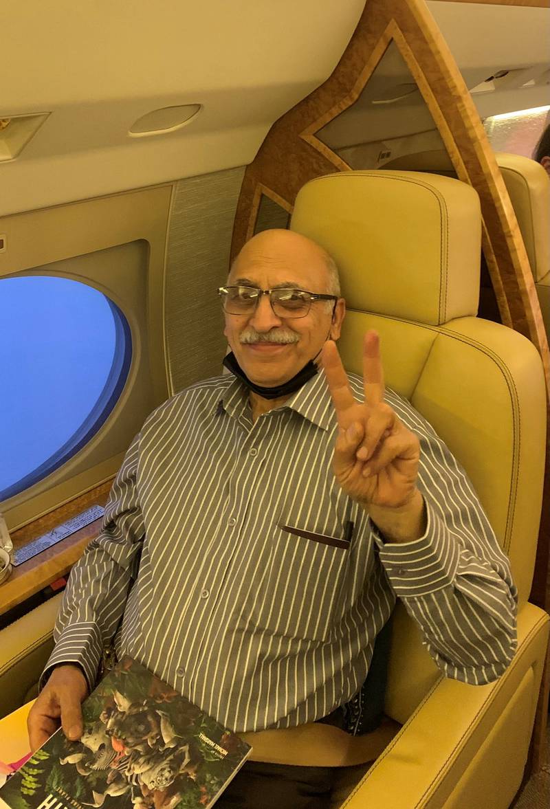 Mr Ashoori gestures as he sits in the plane heading to London. Reuters