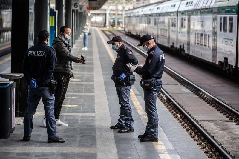 Police check on a man at the Cadorna railway station in Milan.AP