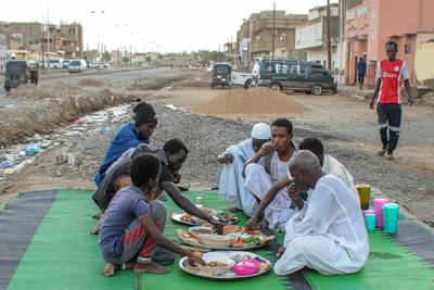 People gather for a meal to break their fast during Ramadan in Port Sudan. AFP