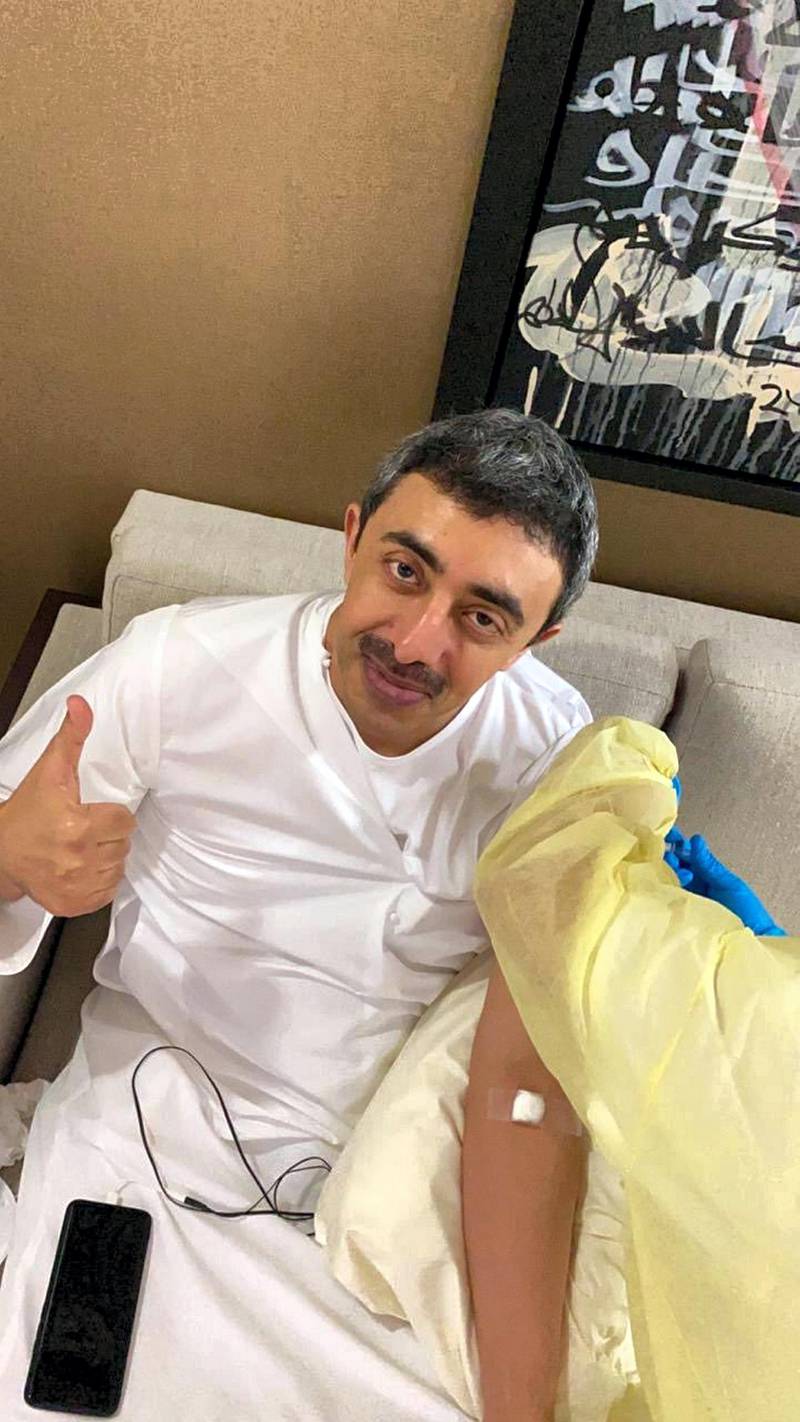 Sheikh Abdullah bin Zayed, Minister of Foreign Affairs and International Co-operation, gives a thumbs up as he is vaccinated against Covid-19.