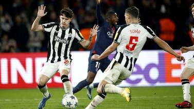 PSG forward Ousmane Dembele, rear, appeals for a penalty after the ball struck the body of Newcastle United defender Timo Livramento, left, before the ball bounced up on to his arm. EPA