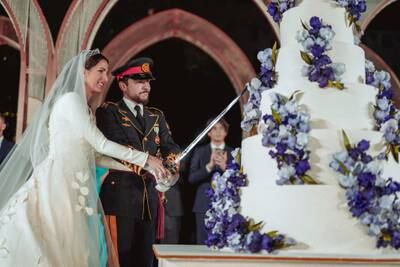 Jordan's Crown Prince Hussein and Princess Rajwa cut a seven-tier cake on the day of their wedding. Reuters 