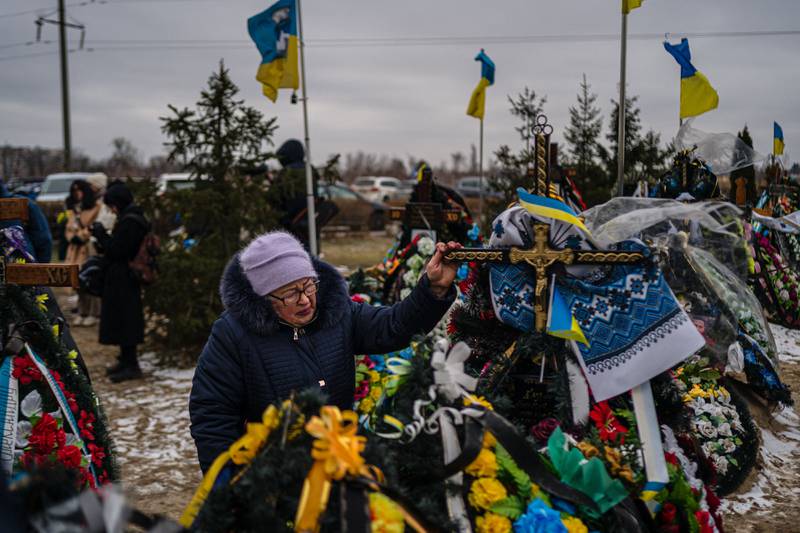 A grieving mother visits a cemetery near Kyiv on the anniversary of Russia's invasion of Ukraine. AFP