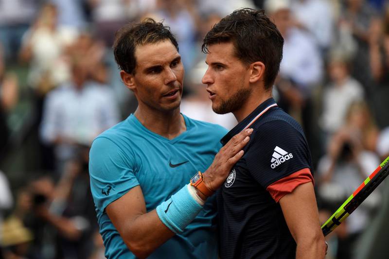 Spain's Rafael Nadal, left, embraces Austria's Dominic Thiem after victory  at the end of their men's singles final match. Eric Ferferberg / AFP