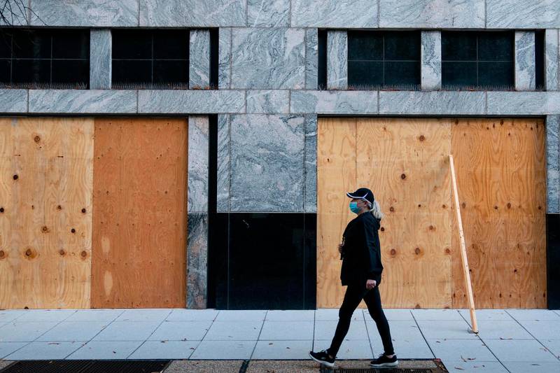 Wooden boards protect a Starbucks location near the White House in Washington, DC. Many Washington businesses are boarding up windows in preparation for possible election related violence.  AFP