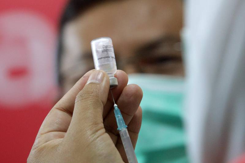 A health worker holds a vial of a Covid-19 vaccine at Banda Aceh General Hospital, in Banda Aceh, Indonesia. EPA