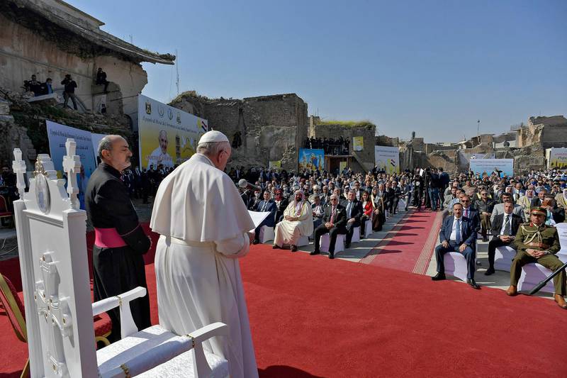 Pope Francis, surrounded by religious dignitaries at a square near the ruins of the Syriac Catholic Church of the Immaculate Conception. AFP