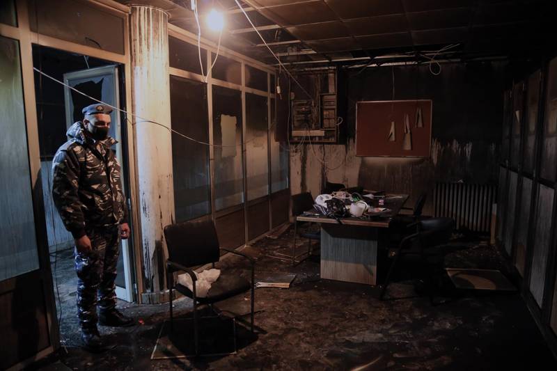 A policeman looks at the damage inside a burned-out office on Tripoli Saraya Square where is a police station and the Sunni Sharia Court were set on fire in protests against the economic situation. EPA