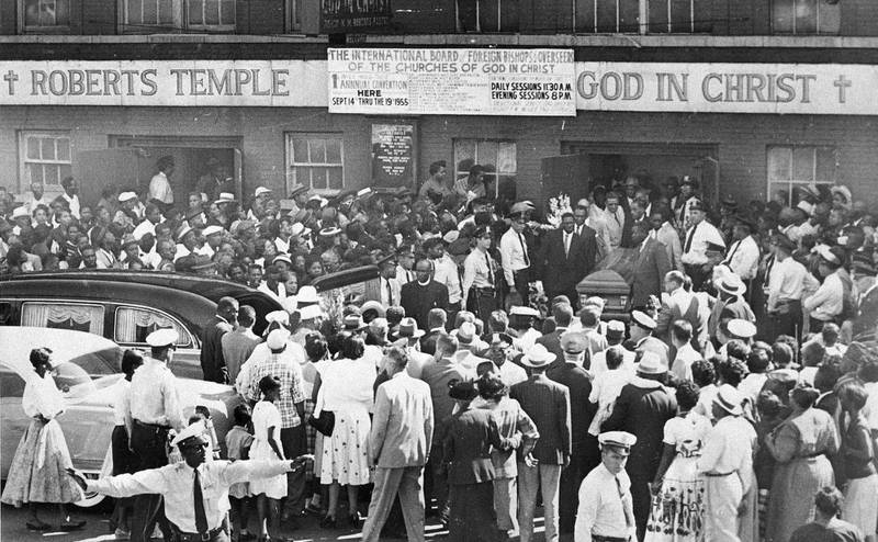 A large crowd gathers outside the Roberts Temple Church of God In Christ in Chicago, September 6, 1955, as pallbearers carry the casket of Emmett Till. AP