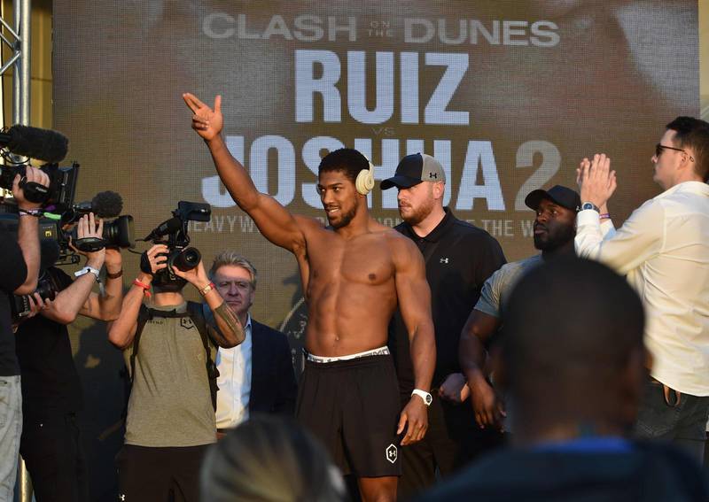 Anthony Joshua gestures during his official weigh-in. AFP
