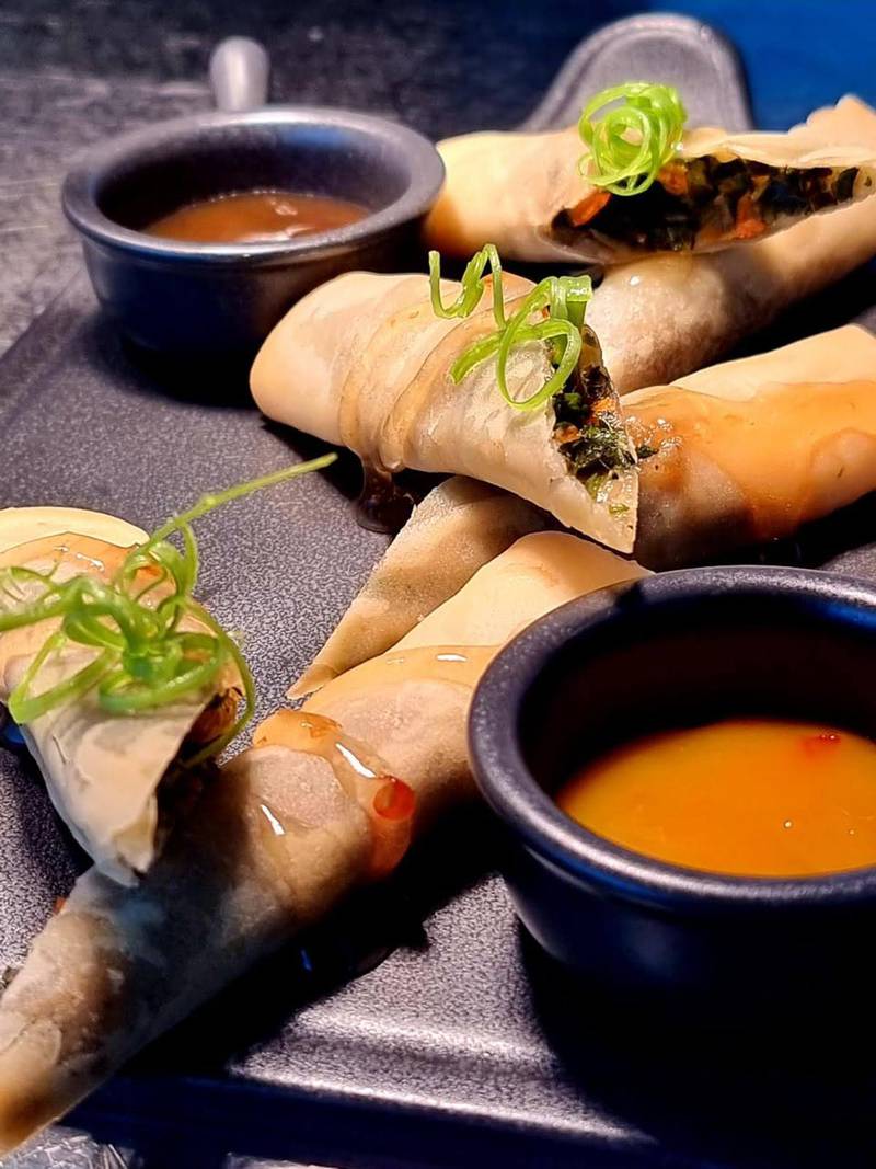 The callaloo spring rolls are served with lime plum and sweet chilli sauces.