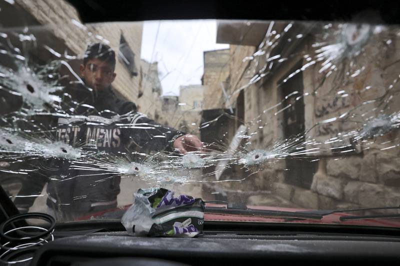 A bullet-riddled windshield outside a house that was targeted in the raid. AFP