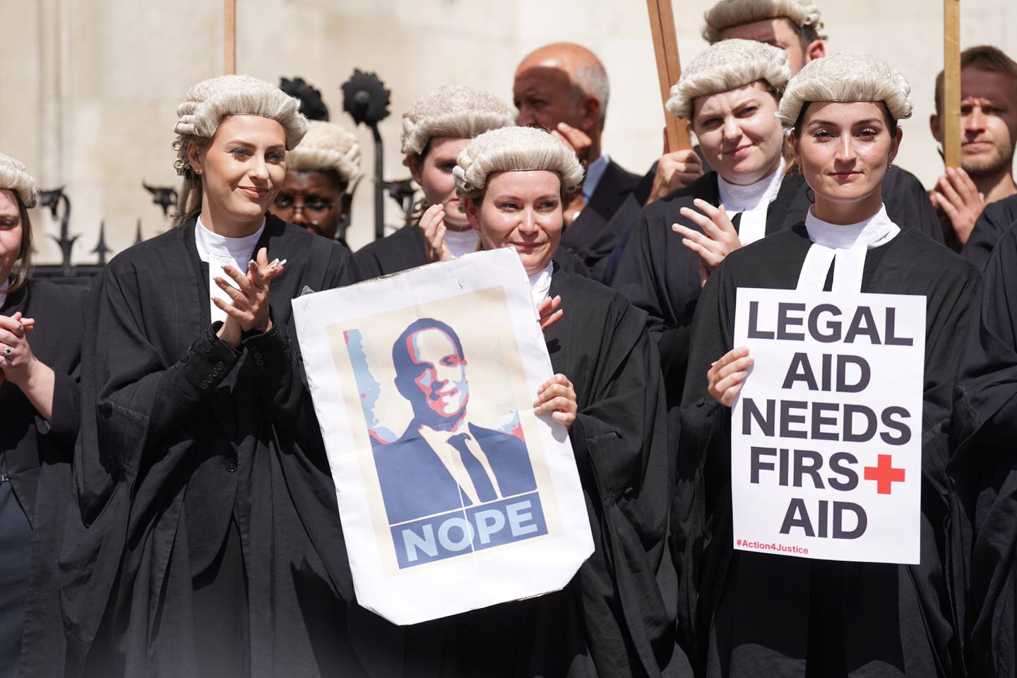 Criminal defence barristers gather outside the Royal Courts of Justice in London to support the ongoing Criminal Bar Association action over government set fees for legal aid advocacy work, on July 4. PA Wire