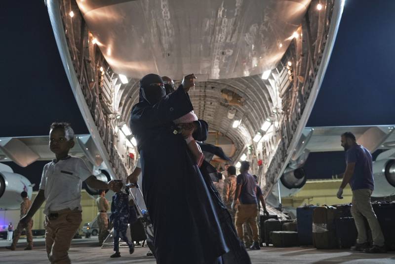 Evacuees disembark at Al Udeid Air Base in Qatar. AP