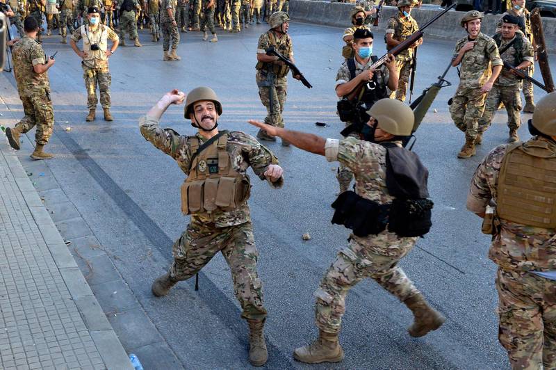A Lebanese army soldier throw stones at anti-government protesters during a protest on the road leading to the Presidential palace in Baabda, east Beirut.  EPA