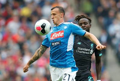 Napoli's Vlad Chiriches in action with Liverpool's Divock Origi. Reuters
