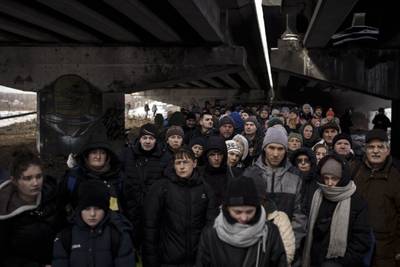 Ukrainians  under a bridge as they try to flee across the Irpin River on the outskirts of Kyiv. AP