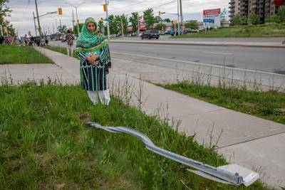Torpenky Khan looks at a street sign flattened when four of five members of a Muslim family were killed by a hit-and-run driver in London, Ontario, Canada. AP Photo