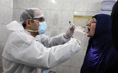 A doctor checks a patient at the Imbaba Fevers Hospital in Cairo. EPA