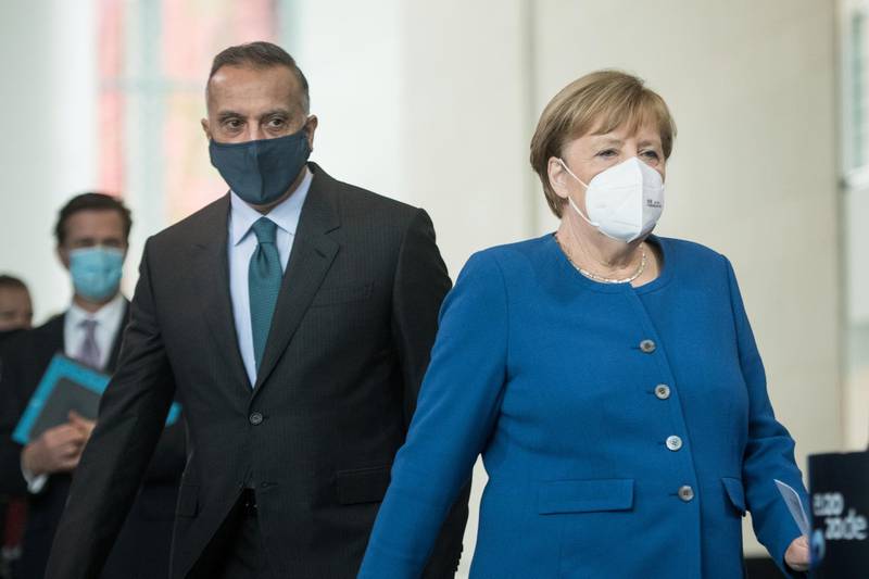 German Chancellor Angela Merkel and Mustafa Al Kadhimi arrive for a news conference at the Chancellery in Berlin, Germany. Reuters